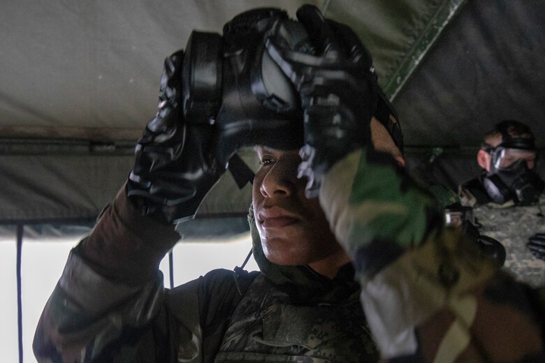 Staff Sgt. Gabriel Sigaoat, 374th Operations Support Squadron, takes off his mask inside the gas mask confidence chamber