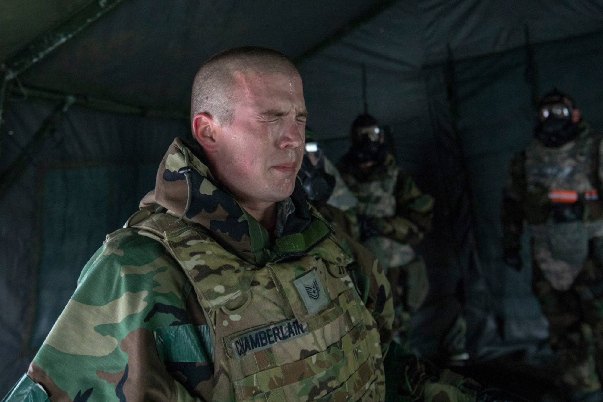 Tech. Sgt. Aaron Chamberlain, 374th Maintenance Group base engine manager, is exposed to CS gas inside the gas mask confidence chamber