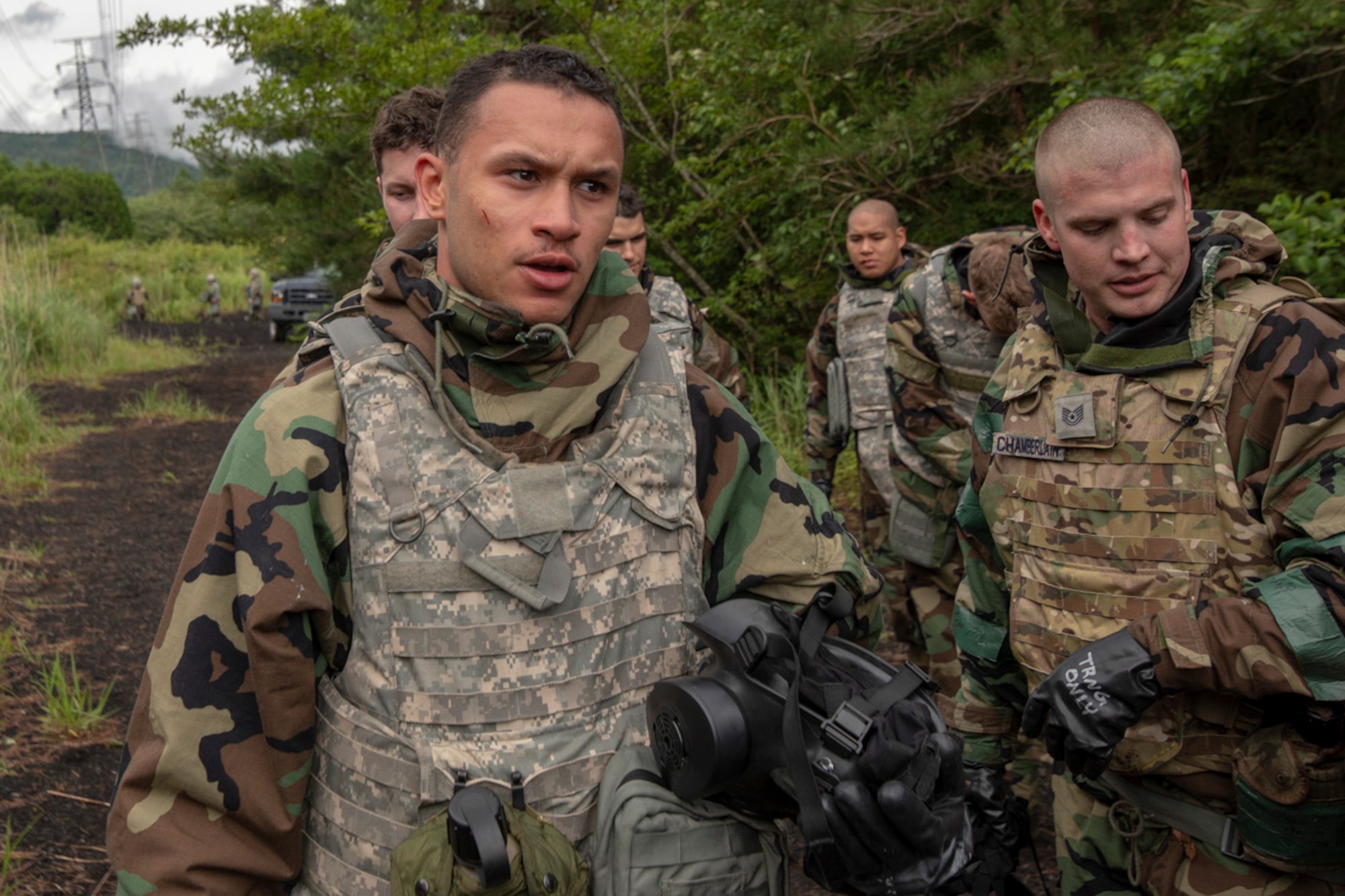 Airman 1st Class Ramon Dickerson, left, 374th Force Support Squadron postal clerk, take a deep breath after experiencing CS gas