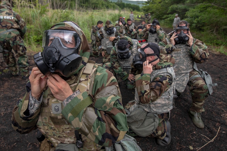 Airmen with the 374th Airlift Wing don their M50 Joint Service General Purpose Field Mask