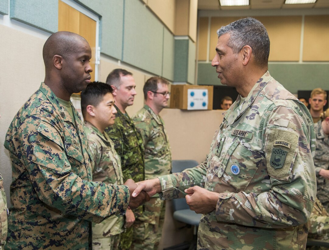 USAG CAMP HUMPHREYS, Korea – Gunnery Sgt. Ryan Gray (left), U.S. Forces Korea Operations staff non-commissioned officer in charge, receives a coin for outstanding performance from Gen. Vincent Brooks, commander of United Nations Command, USFK, and Combined Forces Command here, July 10.  Gray aggregated 90 foreign officers into the staff for training while serving as acting USFK sergeant major of Camp Walker for UNC and USFK. (Official U.S. Marine Corps photo by staff/Released)
