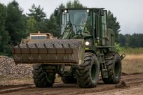 Sgt. Zac Hartley, a horizontal construction engineer in the West Virginia Army National Guard, assigned to 812th Engineer Company, 1092nd Engineer Battalion, 111th Engineer Brigade based out of Eleanor, West Virginia, operates a front end loader to place gravel at Drawsko Pomorskie Training Area, Poland, during Resolute Castle, July 12, 2018.