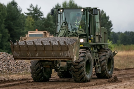 Sgt. Zac Hartley, a horizontal construction engineer in the West Virginia Army National Guard, assigned to 812th Engineer Company, 1092nd Engineer Battalion, 111th Engineer Brigade based out of Eleanor, West Virginia, operates a front end loader to place gravel at Drawsko Pomorskie Training Area, Poland, during Resolute Castle, July 12, 2018.