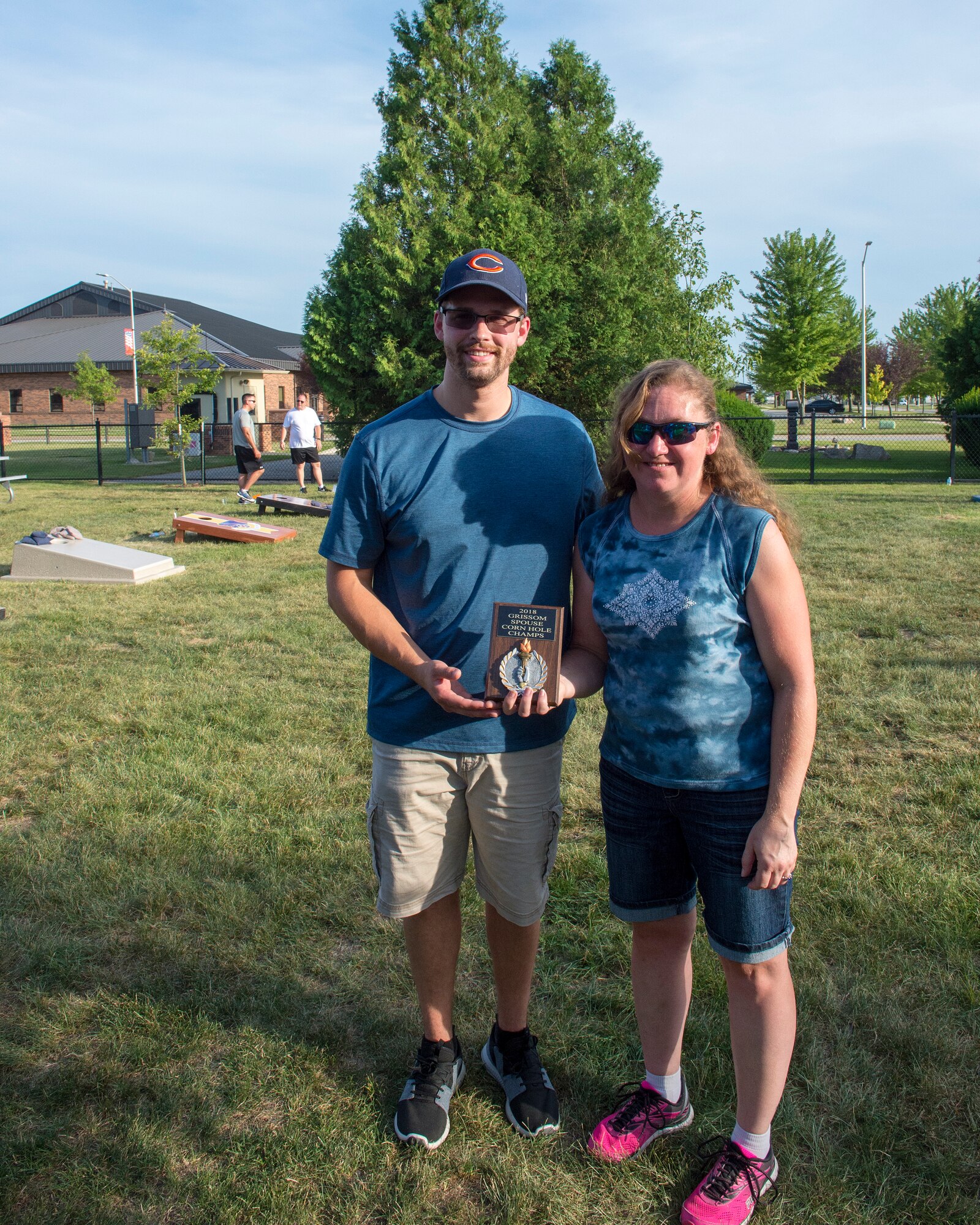 Zack Storms, left, and Natalie Main, took first place in  and Robert Laviolette 434th Civil Engineer Squadron pose with their trophy for winning the spouse bracket of the first Grissom corn hole tournament here July 14, 2018. The 434th AMDS swept the competition defeating the 434th Force Support Squadron in the final round. (U.S. Air Force photo/Staff Sgt. Jami K. Lancette)