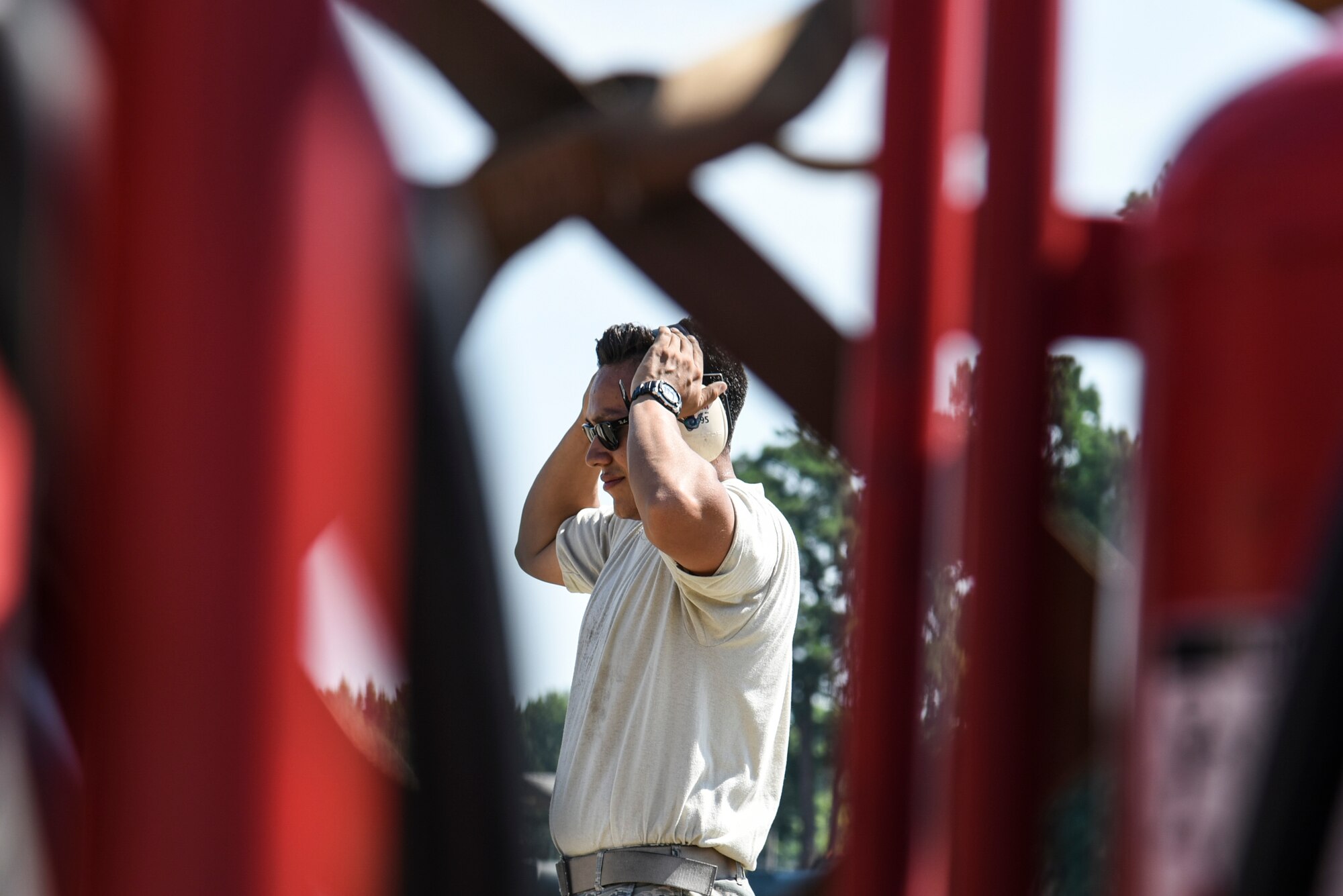 U.S. Air Force Senior Airman Daniel Abbiati, 20th Aircraft Maintenance Squadron support technician, adjusts his hearing protection on the flight line at Shaw Air Force Base, S.C., July 11, 2018
