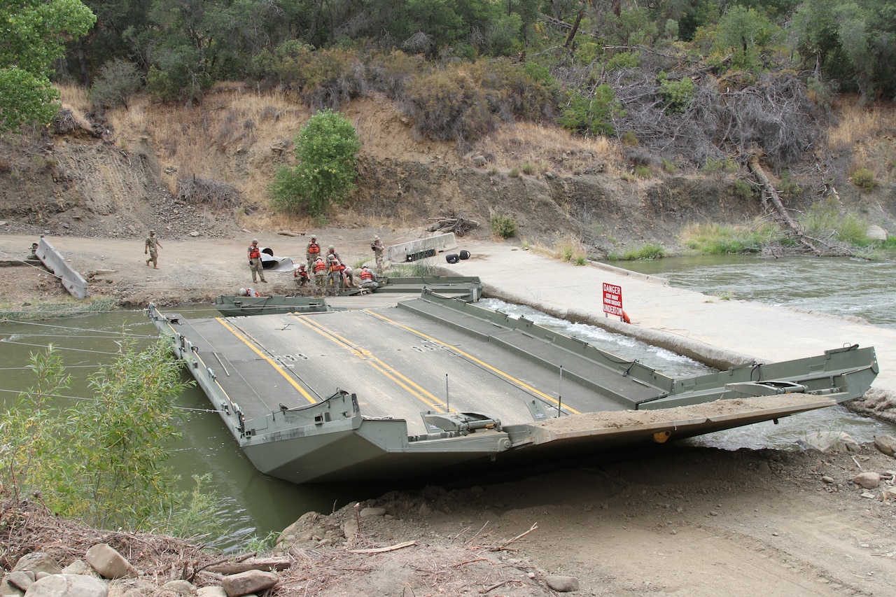 Engineers assemble a floating bridge.