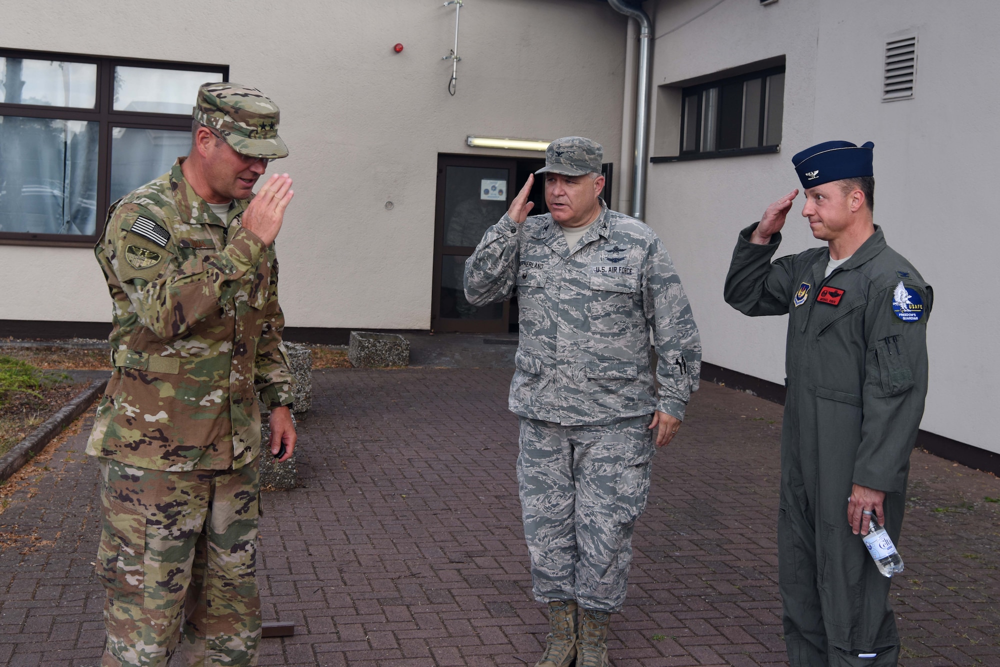 U.S. Air Force Col. Michael Rider (right), Warrior preparation center commander and Col. John Sutherland (center), U.S. Air Forces in Europe-Air Forces Africa A6 director salute U.S. Air Force Maj. Gen. Jon T. Thomas, (left) USAFE-AFAFRICA, director of operations strategic deterrence and nuclear integration as he departs Tacet Venari on Ramstein Air Base, Germany, July 12, 2018. “This exercise demonstrates how we can defend our networks and shows our capabilities at an installation and functional level,” said Thomas.