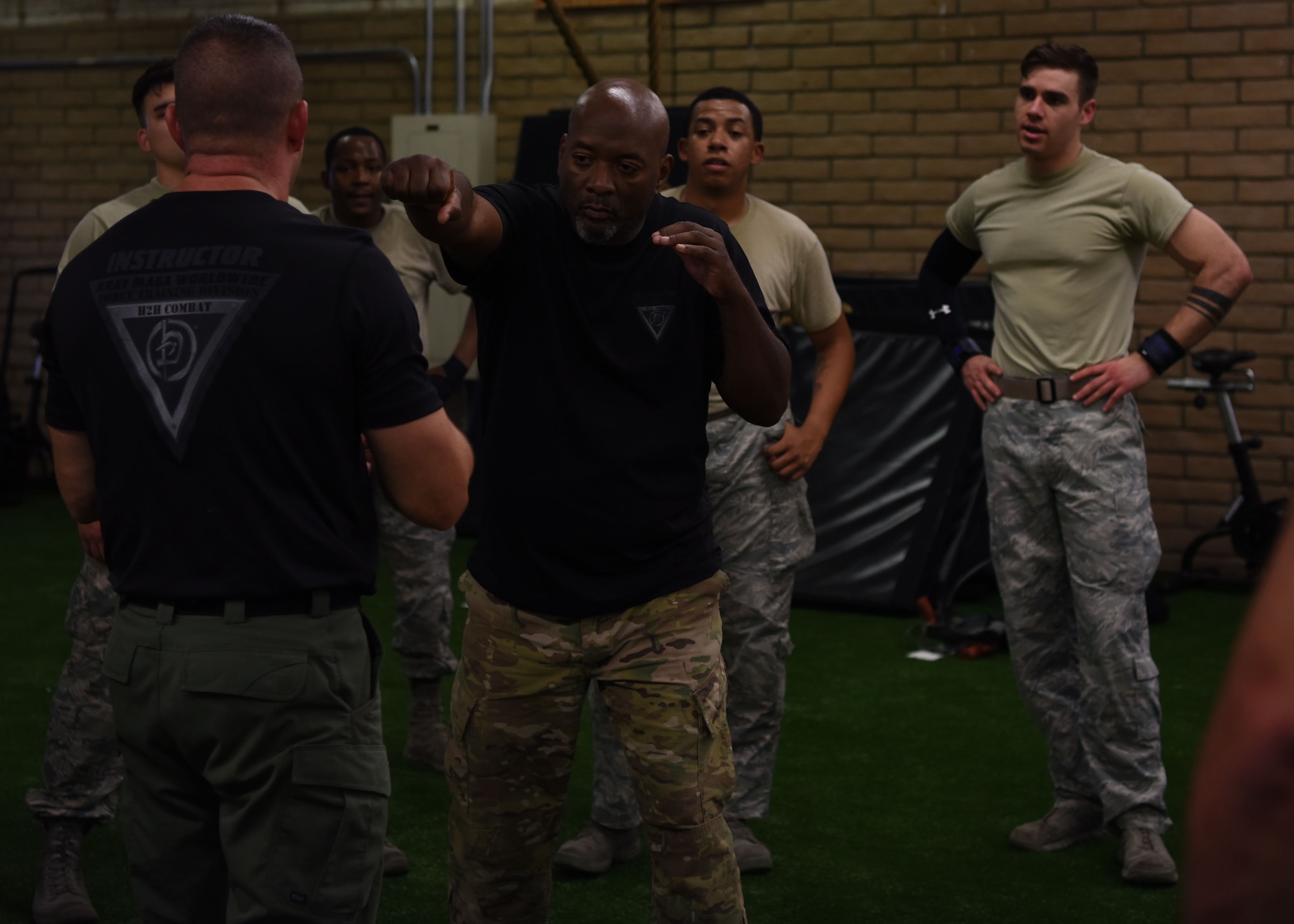 Allen Payne and Bobby Cumby, Krav Maga instructors, demonstrate a punch defense maneuver during training at the Tactical Integrated Training and Nutrition Arena July 12, 2018, at Luke Air Force Base, Ariz.