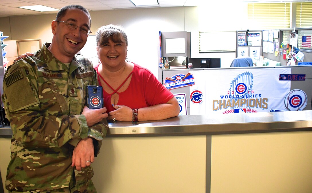 The 932nd Airlift Wing's official webpage is created for great wing members like these.  Two of the top ten Chicago Cubs fans in the unit spend a brief moment reminiscing about a World Series victory during a visit.  Chaplain (Maj.) Michael Williams, at left, stops by the office of Donna Kocurek to check paperwork with the financial expert at Scott Air Force Base, Ill.  Looking forward to the second half of the 2018 season, she said, "I'm happy two of the Cubs are in the home run derby event (Javier Baez and Kyle Schwarber) and the rest of the season looks like It's a tight race between Milwaukee and the Chicago Cubs, and will probably come all the way down to the last week."  Kocurek is well known at the 932nd Airlift Wing for taking care of military members and their pay documents.  (U.S. Air Force photo by Lt. Col. Stan Paregien)