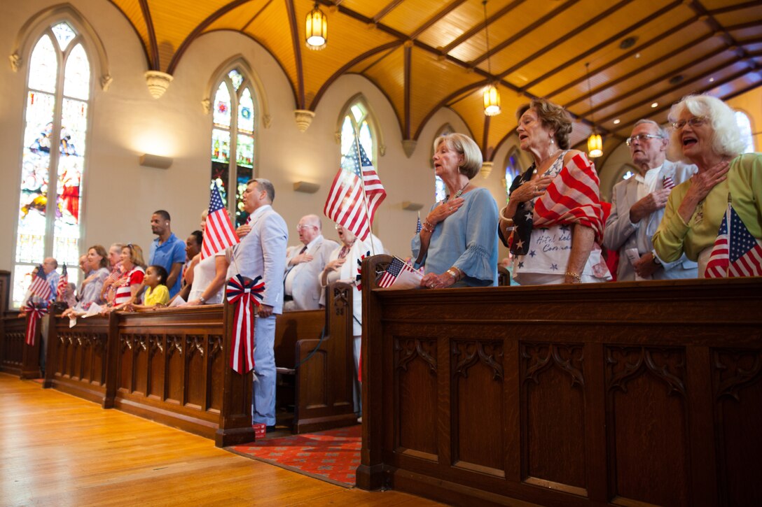 Mr. Gregg T. Habel, executive director of Marine Forces Reserve and Marine Forces North, and attendees of the 20th Annual Patriotic Music Festival recite the Pledge of Allegiance at the Trinity Episcopal Church, New Orleans on July 1, 2018. The music festival is one of multiple concerts performed by the Marine Forces Reserve Band for their Independence Day concert series. (U.S. Marine Corps photo by Lance Cpl. Tessa D. Watts)