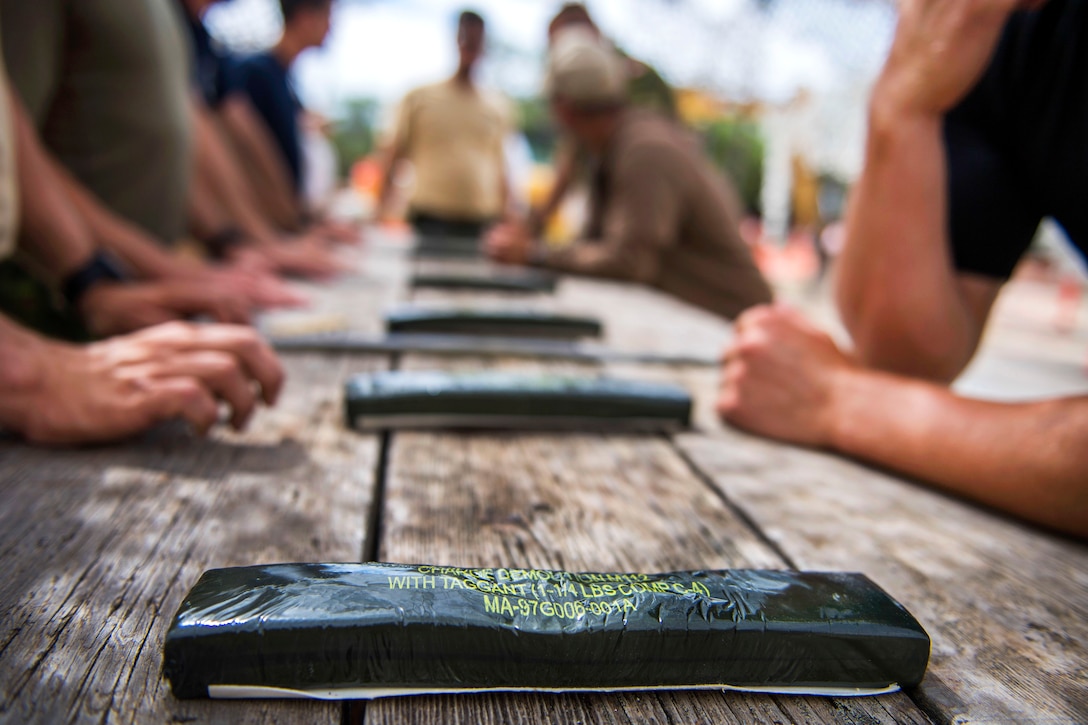 U.S. sailors, Coast Guard members and Canadian forces prepare C-4 before conducting an explosive ordnance disposal exercise.