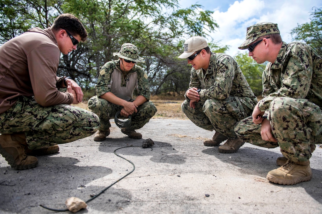 U.S. sailors conduct a test burn on a time fuse during an explosive ordnance disposal exercise.