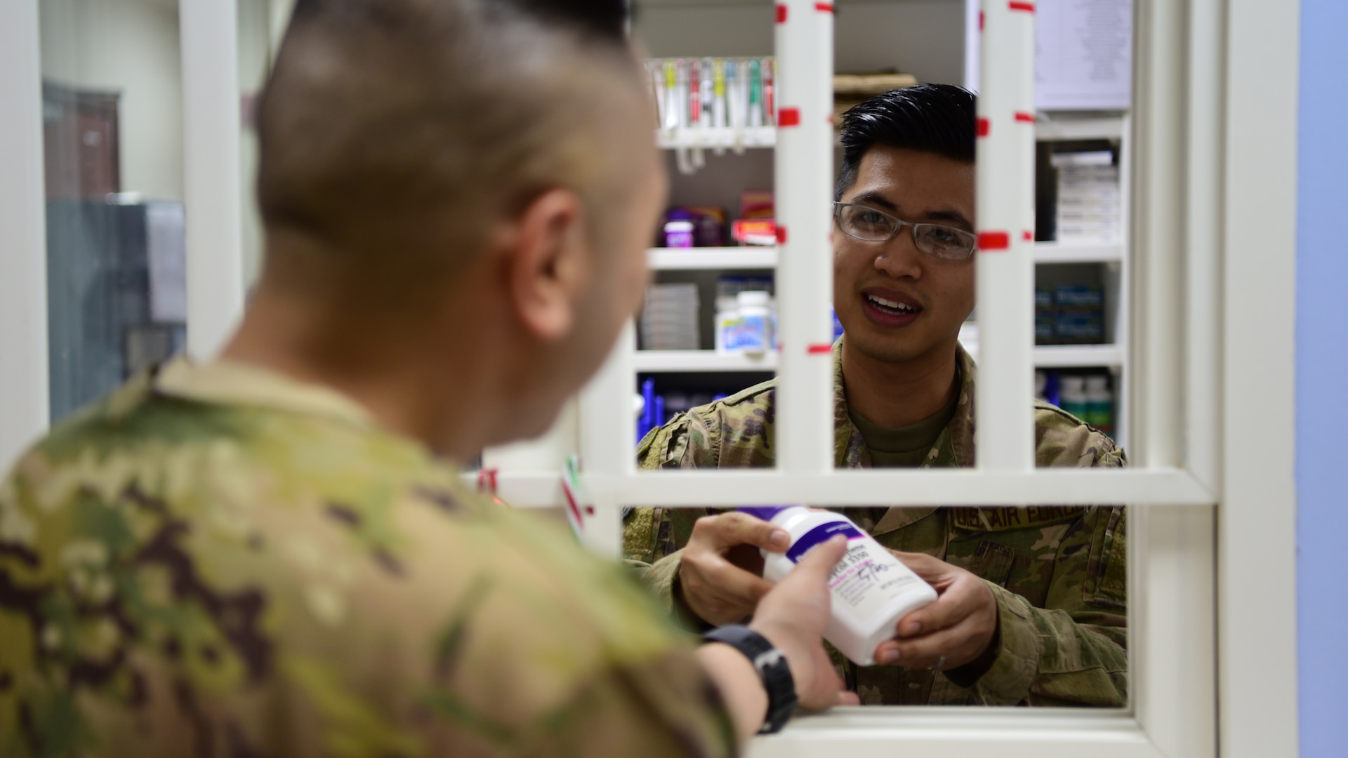 Tech. Sgt. Julian Tayag, 386 EMDG pharmacy non-commissioned officer-in-charge, provides medication to a coworker June 22, 2018, at an undisclosed location in Southwest Asia. In early May 2018, Tayag was selected to attend the Interservice Physician Assistant Program at Joint Base San Antonio-Fort Sam Houston.