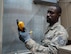 Staff Sgt. Cheick Kamagate, Heating, Ventilation, Air Conditioning/Refrigeration and Control technician assigned to the 512th Civil Engineer Squadron Reserve Unit at Dover Air Force Base, Delaware checks the air supply temperature going into a 57th maintenance facility on Nellis Air Force Base. The 99th CES HVAC shop has prepared for the summer heat by utilizing over 50 Air Reserve Component technicians across 13 other bases. (U.S. Air Force photo by Airman Bailee A. Darbasie)