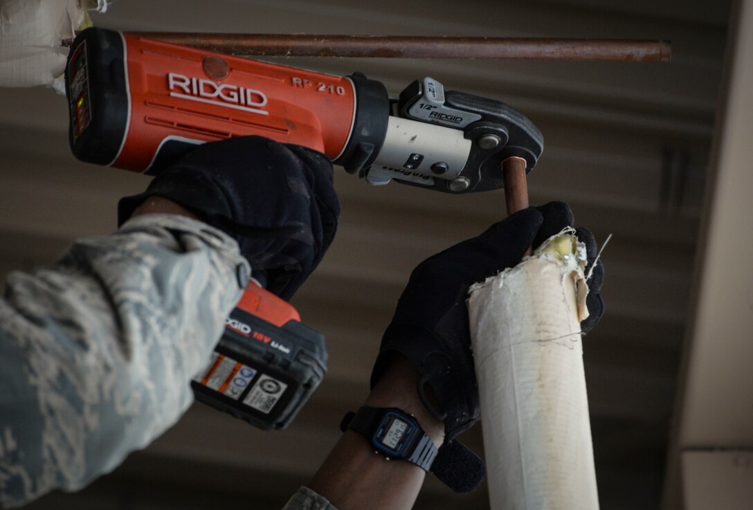 Airman 1st Class Johnathan Daniels, Heating, Ventilation, Air Conditioning/Refrigeration and Control technician assigned to the 99th Civil Engineer Squadron, repairs a broken water pipe at a 57th maintenance facility on Nellis Air Force Base. HVAC technicians are responsible for 6,670 pieces of equipment, equating to over 17,000 hours of preventative maintenance for sustainability.  (U.S. Air Force photo by Airman Bailee A. Darbasie)