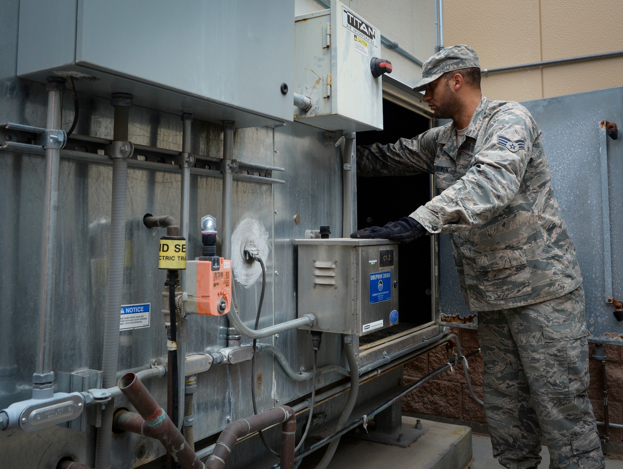 Senior Airman Matthew Bowen, Heating, Ventilation, Air Conditioning/Refrigeration and Control technician assigned to the 99th Civil Engineer Squadron, inspects an HVAC unit at a 57th maintenance facility on Nellis Air Force Base. The specific internal temperatures needed in every facility across the base are imperative for the functionality of the equipment and personnel. (U.S. Air Force photo by Airman Bailee A. Darbasie)