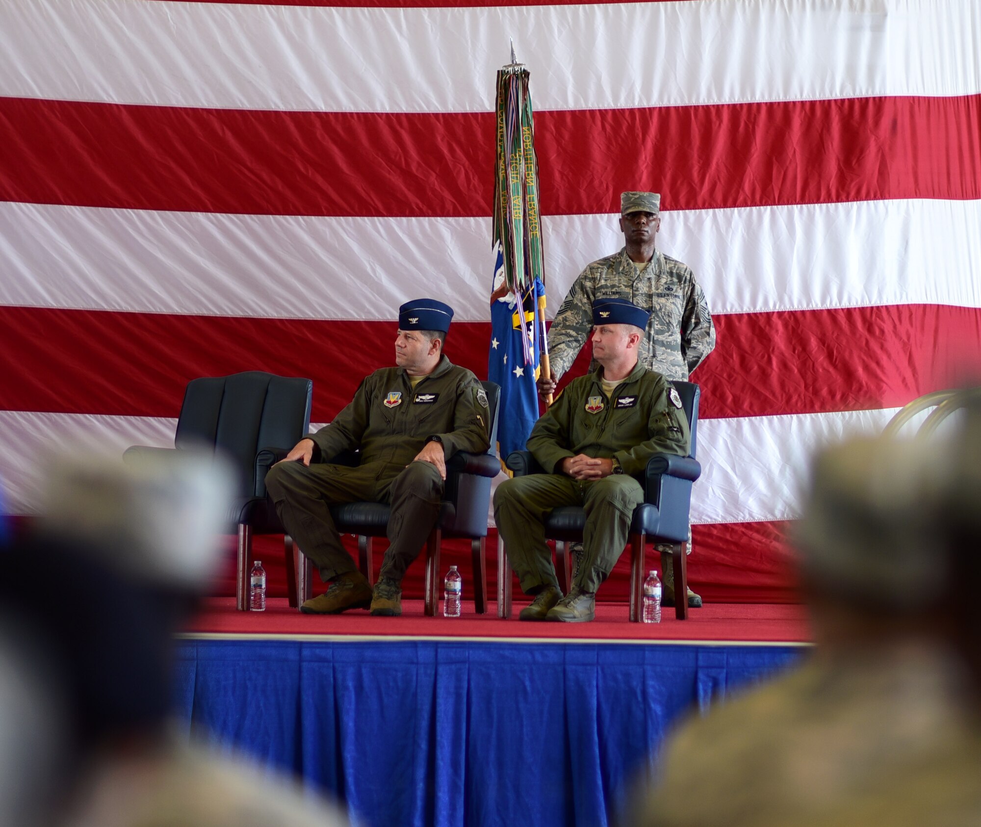 Chief Master Sgt. Craig Williams stands while holding the ceremonial guidon during the wing change of command ceremony.