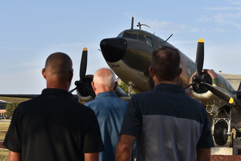 Clayton Garland, Louis Garland and Nathan Garland, decedents of late Chief Warrant Officer Louis F. Garland, view the EC-47 static plane display on Goodfellow Air Force Base, Texas, July 13, 2018. The Garlands visited to learn about the legacy of their forbearer, Louis F. Garland and to pay their respects. (U.S. Air Force photo by Senior Airman Randall Moose/Released)