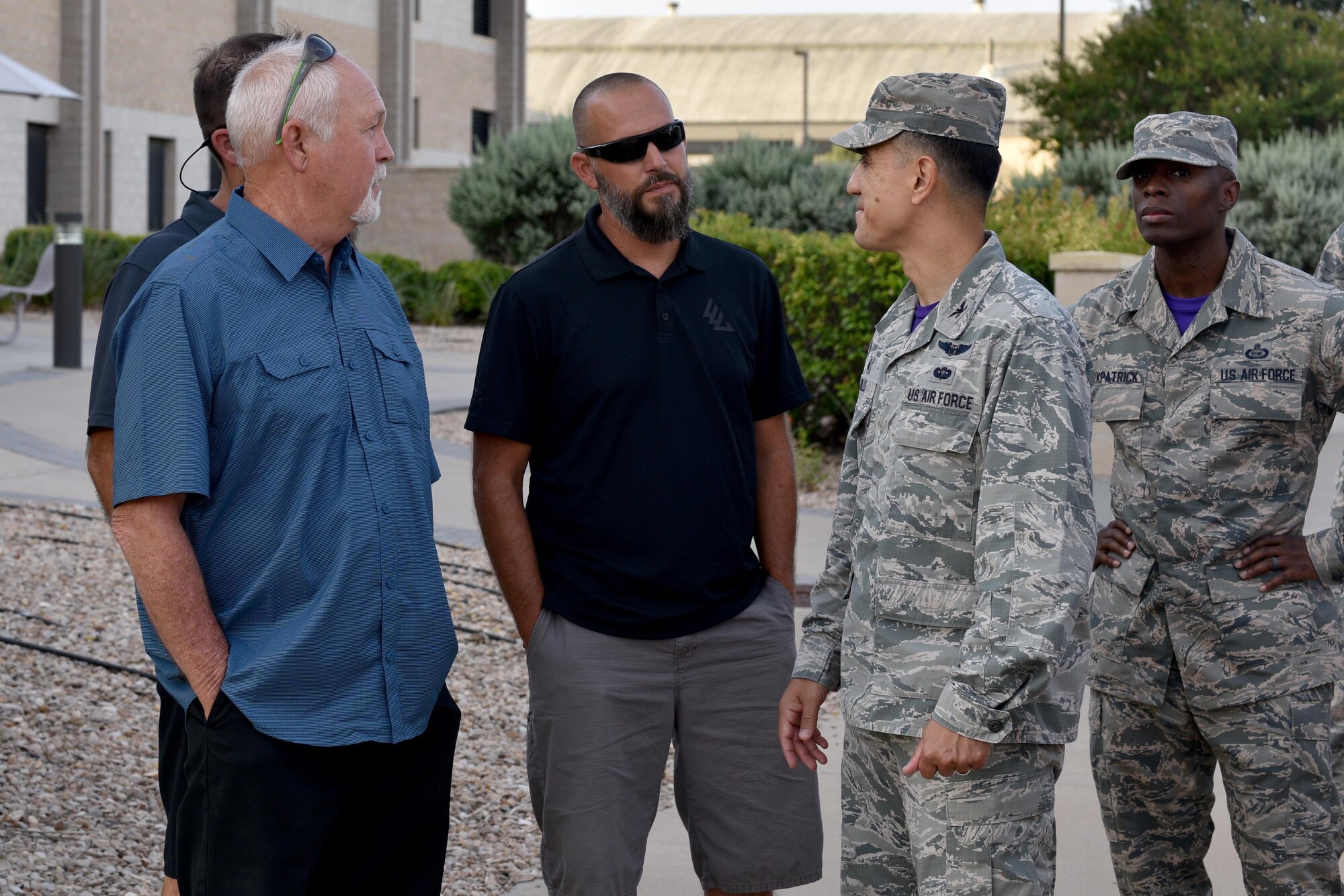 Louis Garland and Clayton Garland, decedents of late Chief Warrant Officer Louis F. Garland, meet with U.S. Air Force Ricky Mills, 17th Training Wing commander and Chief Master Sgt. Lavor Kirkpatrick, 17th TRW command chief, at the Norma Brown building on Goodfellow Air Force Base, Texas, July 13, 2018. Mills met with the Garlands before their tour of the Louis F. Garland Department of Defense Fire Academy. (U.S. Air Force photo by Senior Airman Randall Moose/Released)