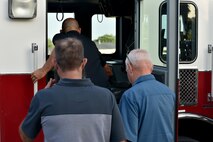 Nathan Garland, Clayton Garland and Louis Garland, decedents of late Chief Warrant Officer Louis F. Garland, board a firetruck to tour Goodfellow Air Force Base, Texas, July 13, 2018. The Garlands traveled from the Norma Brown building to the Louis F. Garland Department of Defense Fire Academy on a firetruck. (U.S. Air Force photo by Senior Airman Randall Moose/Released)