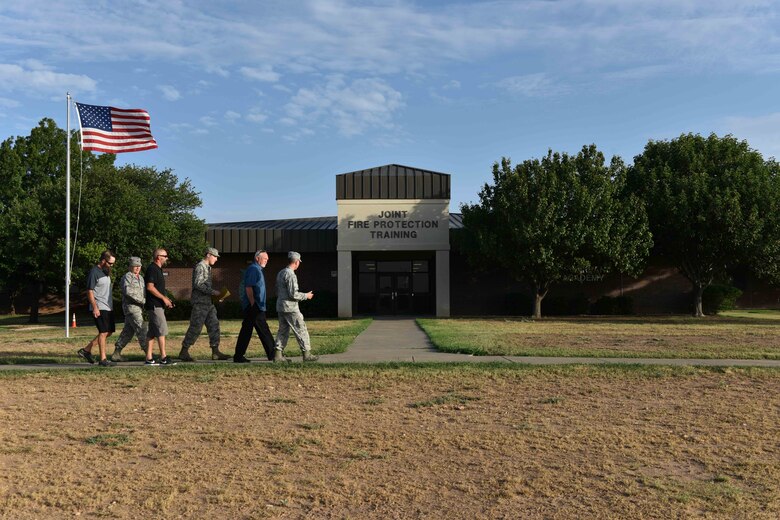 The Garlands, decedents of late Chief Warrant Officer Louis F. Garland, walk towards the Louis F. Garland Department of Defense Fire Academy on Goodfellow Air Force Base, Texas, July 13, 2018. Goodfellow dedicated the fire academy to Chief Warrant Officer Garland in 1995. (U.S. Air Force photo by Senior Airman Randall Moose/Released)