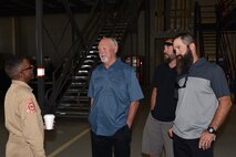 Leonard Finley, 312th Training Squadron instructor, speaks with Louis Garland, Clayton Garland and Nathan Garland, decedents of late Chief Warrant Officer Louis F. Garland, in the Louis F. Garland Department of Defense Fire Academy on Goodfellow Air Force Base, Texas, July 13, 2018. Finley knew Chief Warrant Officer Garland and reminisced with his son and grandson during their visit to Goodfellow. (U.S. Air Force photo by Senior Airman Randall Moose/Released)