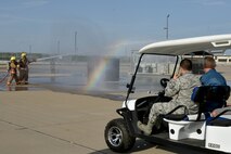 U.S. Air Force Master Sgt. Roy Campos, 312th Training Squadron advance courses chief, and Louis Garland, son of late Chief Warrant Officer Louis F. Garland, watch trainees put out a simulated dumpster fire in the Louis F. Garland Department of Defense Fire Academy on Goodfellow Air Force Base, Texas, July 13, 2018. The trainees practice their firefighting techniques using live fire to prepare them for their careers. (U.S. Air Force photo by Senior Airman Randall Moose/Released)