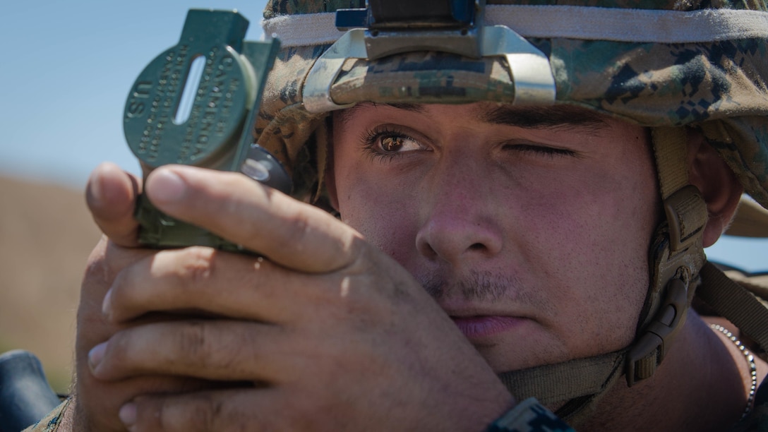 U.S. Marine Corps Pfc. Alex W. Michael, an antitank missile gunner with 1st Tank Battalion, 1st Marine Division (MARDIV), looks through a lensatic compass during the Rifle Squad Competition on Marine Corps Base Camp Pendleton, Calif., June 27, 2018