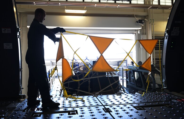 U.S. Air Force Master Sgt. Jonathan Lauterbach, NCO in charge of Readiness Flight assigned to the 56th Air Refueling Squadron, rehangs high visibility warning strap following a boom operator simulated cargo training on the Fuselage Trainer, July 10, 2018, at Altus Air Force Base, Okla.