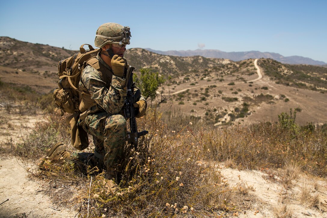 A U.S. Marine with 1st Light Armored Reconnaissance Battalion, 1st Marine Division (MARDIV), gives a situation report after conducting a squad assault on an objective during the Rifle Squad Competition on Marine Corps Base Camp Pendleton, Calif., June 27, 2018.