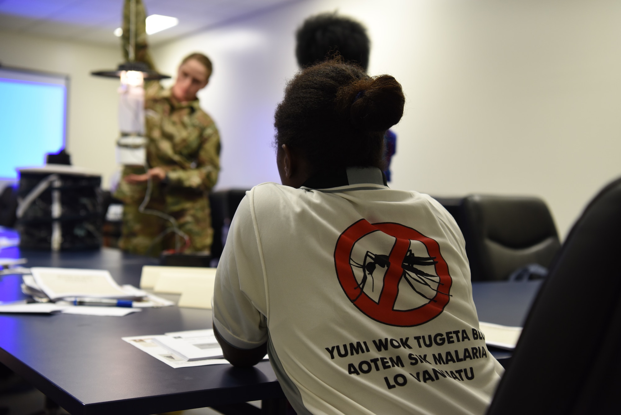 A vector-borne disease control professional from Luganville, Espiritu Santo Island, Vanuatu, observes a demonstration of a mosquito U.V. light trap during a subject matter exchange on vector-borne disease control as part of Pacific Angel (PAC ANGEL) 18-3 in Luganville, Vanuatu, July, 10, 2018.