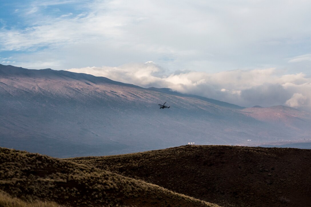A U.S. Marine Corps AH-1Z Viper helicopter flies towards an impact area during close air support as part of Rim of the Pacific (RIMPAC) exercise at Pohakuloa Training Area, Hawaii, July 14, 2018. The training involved pilots working with a joint forward air controller to coordinate the close air support of ground troops.
