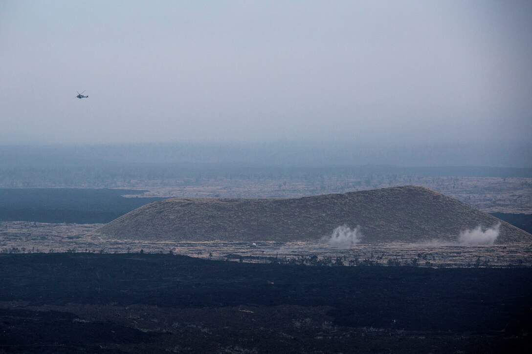 A U.S. Marine Corps AH-1Z Viper helicopter strikes the impact area during close air support as part of Rim of the Pacific (RIMPAC) exercise at Pohakuloa Training Area, Hawaii, July 14, 2018. The training involved pilots working with a joint forward air controller to coordinate the close air support of ground troops.