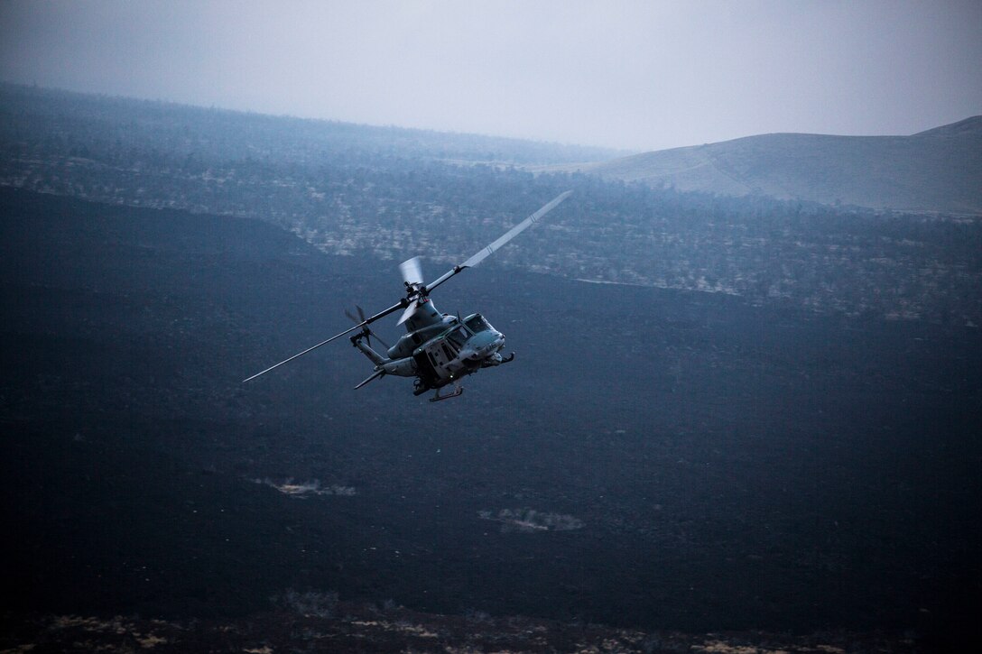 A U.S. Marine Corps UH-1Y Huey flies over the impact area during close air support as part of Rim of the Pacific (RIMPAC) exercise at Pohakuloa Training Area, Hawaii, July 14, 2018. The training involved pilots working with a joint forward air controller to coordinate the close air support of ground troops.