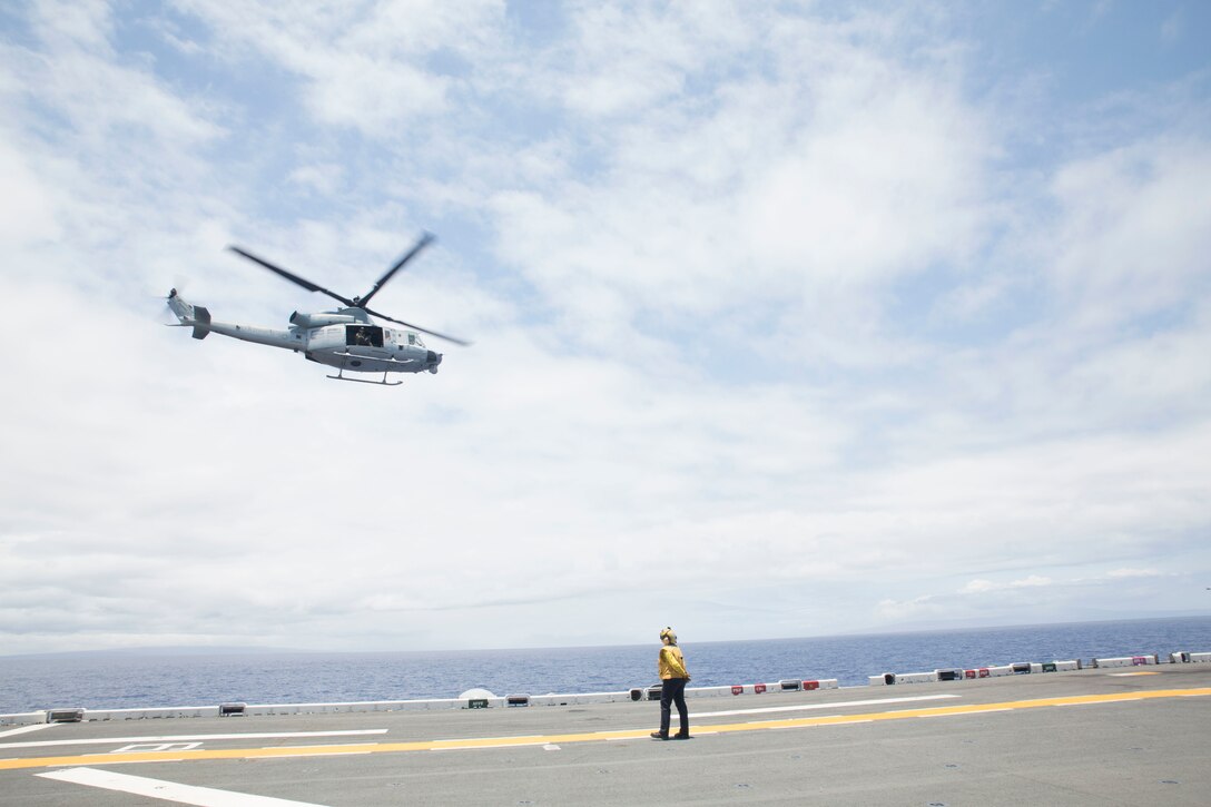A U.S. Marine UH-1Y Huey helicopter departs amphibious assault ship USS Bonhomme Richard (LHD 6) during Rim of the Pacific (RIMPAC) exercise at sea off the coast of Hawaii July 11, 2018. U.S. Marine Corps Col. Michael S. Styskal, commanding officer, 3rd Marine Regiment, visits with the Marines and Sailors aboard the Bonhomme Richard while at sea.