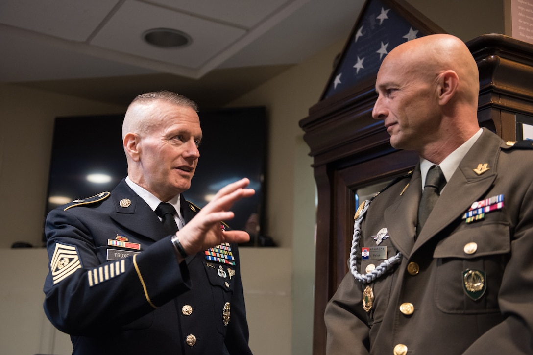 Army Command Sgt. Maj. John W. Troxell talks to a Croatian service member.