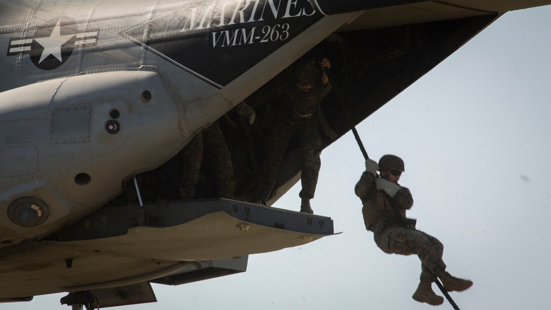 U.S. Marines with Special Purpose Marine Air-Ground Task Force-Crisis Response-Africa fast-rope out of a U.S. Marine Corps MV-22 Osprey at Naval Station Rota, Spain, June 26, 2018. SPMAGTF-CR-AF deployed to conduct crisis-response and theater-security operations in Europe and North Africa. (U.S. Marine Corps photo by Staff Sgt. Britni M. Garcia Green/Released)