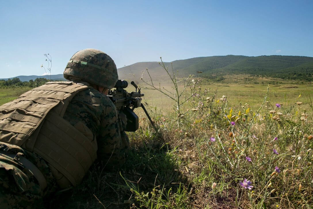 A U.S. Marine with Black Sea Rotational Force 18.1 engages a target using an M249 light machine gun during a deployment for training exercise at Novo Selo Training Area, Bulgaria, July 1, 2018. Marines with Weapons Company, 1st Battalion, 6th Marine Regiment conducted five days of live-fire ranges, enhancing their operational capabilities. (U.S. Marine Corps photo by Cpl. Abrey Liggins/Released)