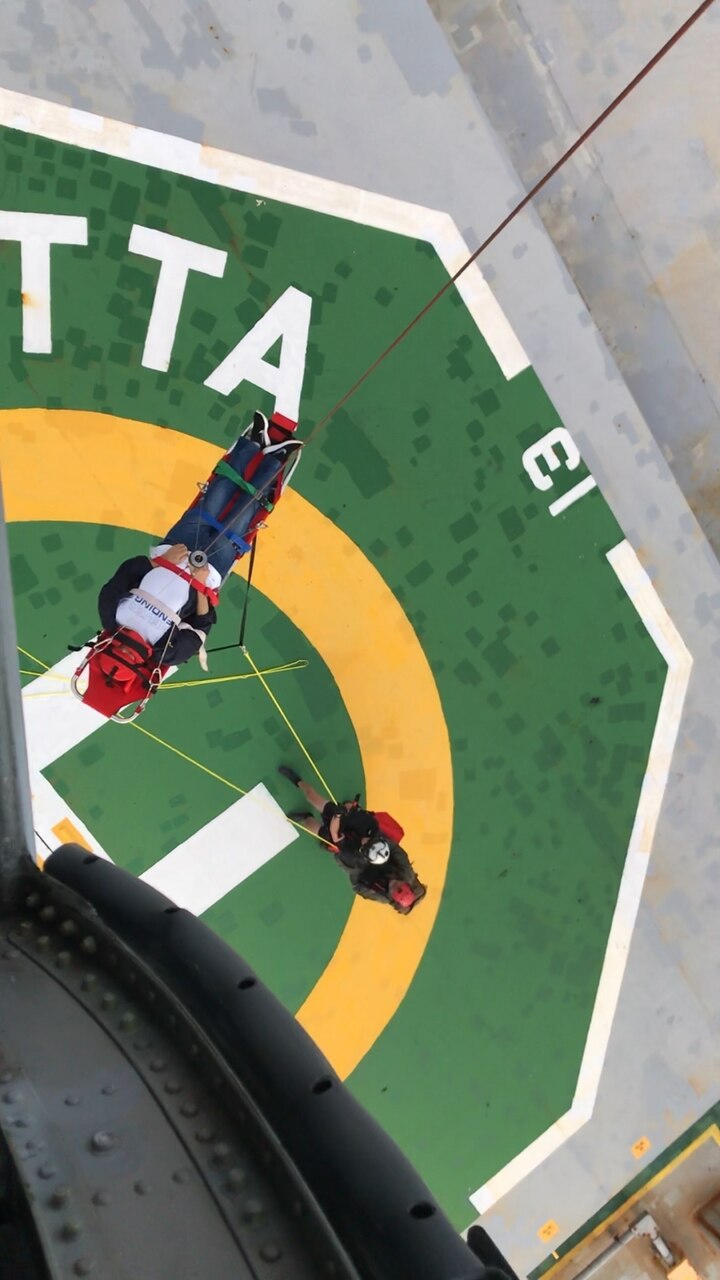 PACIFIC OCEAN (July 15, 2018) -- Aircrewmen from the “Island Knights” of Helicopter Sea Combat Squadron (HSC) 25 evacuate a mariner in distress from a commercial cargo ship near Guam.  HSC-25 provides a multi-mission rotary wing capability for units in the U.S. 7th Fleet area of operations and maintains a Guam-based 24-hour search and rescue and medical evacuation capability, directly supporting U.S. Coast Guard and Joint Region Marianas.