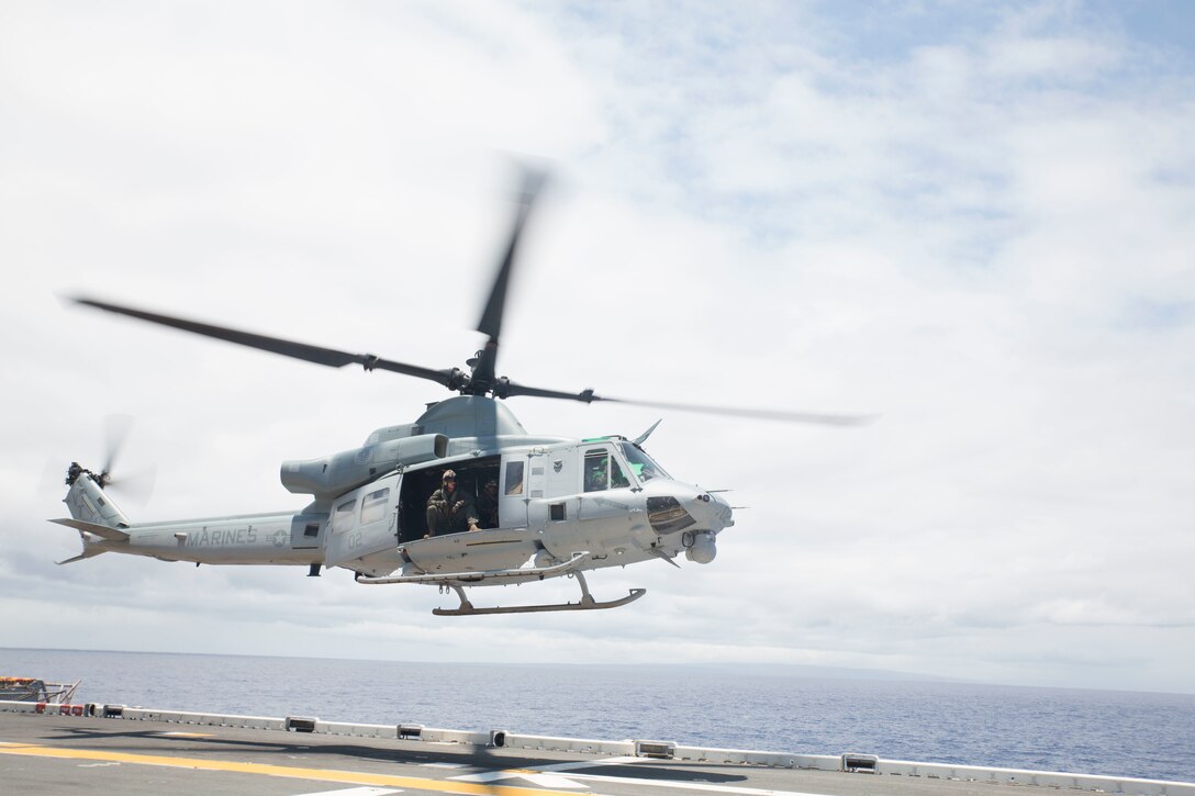 A U.S. Marine Corps UH-1Y Huey helicopter departs the amphibious assault ship USS Bonhomme Richard (LHD 6) during Rim of the Pacific (RIMPAC) exercise at sea off the coast of Hawaii July 11, 2018. U.S. Marine Corps Col. Michael S. Styskal, commanding officer, 3rd Marine Regiment, visits with the Marines and Sailors aboard the Bonhomme Richard while at sea.