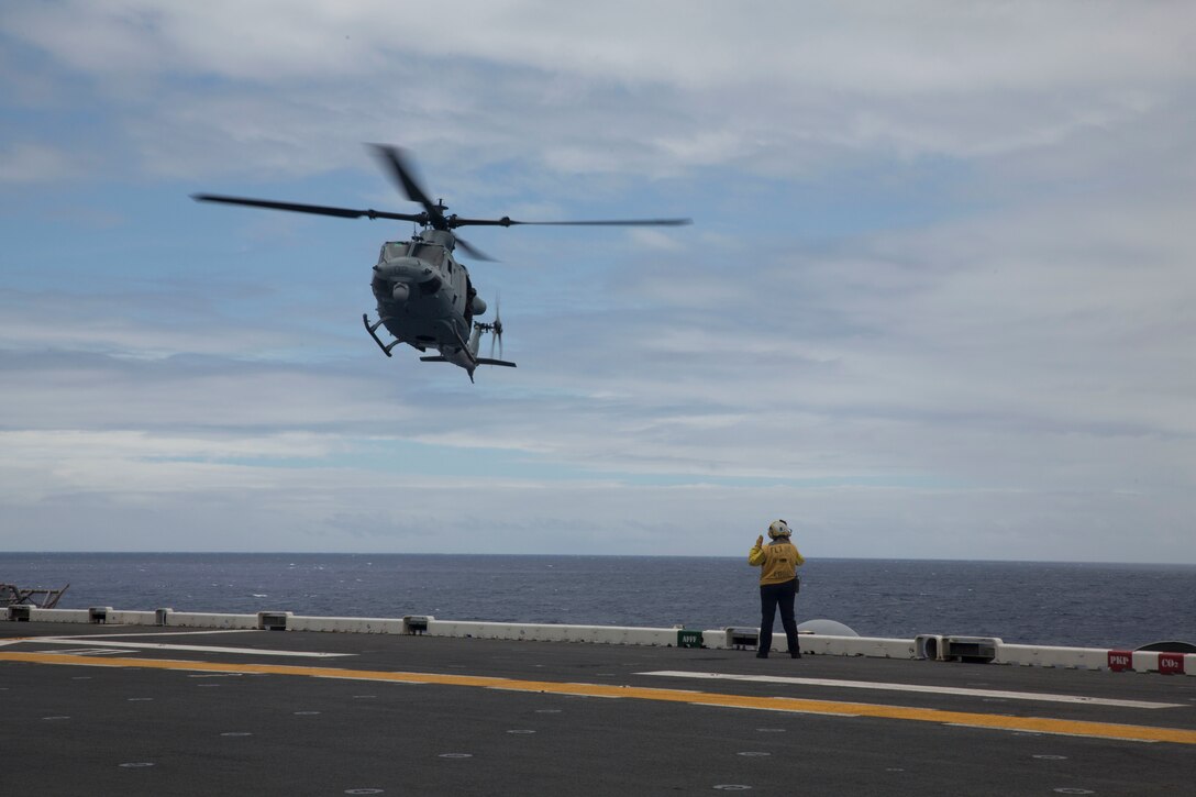 A U.S. Marine UH-1Y Huey helicopter prepares to land on the flight deck of the amphibious assault ship USS Bonhomme Richard (LHD 6) during Rim of the Pacific (RIMPAC) exercise at sea off the coast of Hawaii July 11, 2018. U.S. Marine Corps Col. Michael S. Styskal, commanding officer, 3rd Marine Regiment, visits with the Marines and Sailors aboard the Bonhomme Richard while at sea.