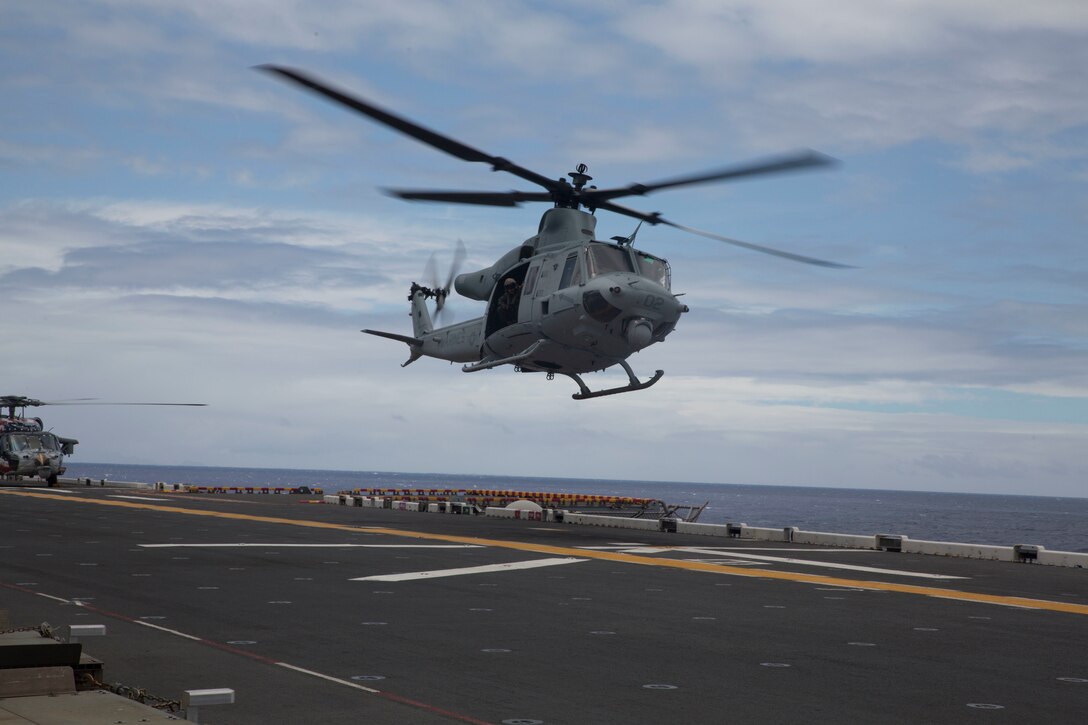 A U.S. Marine UH-1Y Huey helicopter prepares to land on the flight deck of the amphibious assault ship USS Bonhomme Richard (LHD 6) during Rim of the Pacific (RIMPAC) exercise at sea off the coast of Hawaii July 11, 2018. U.S. Marine Corps Col. Michael S. Styskal, commanding officer, 3rd Marine Regiment, visits with the Marines and Sailors aboard the Bonhomme Richard while at sea.
