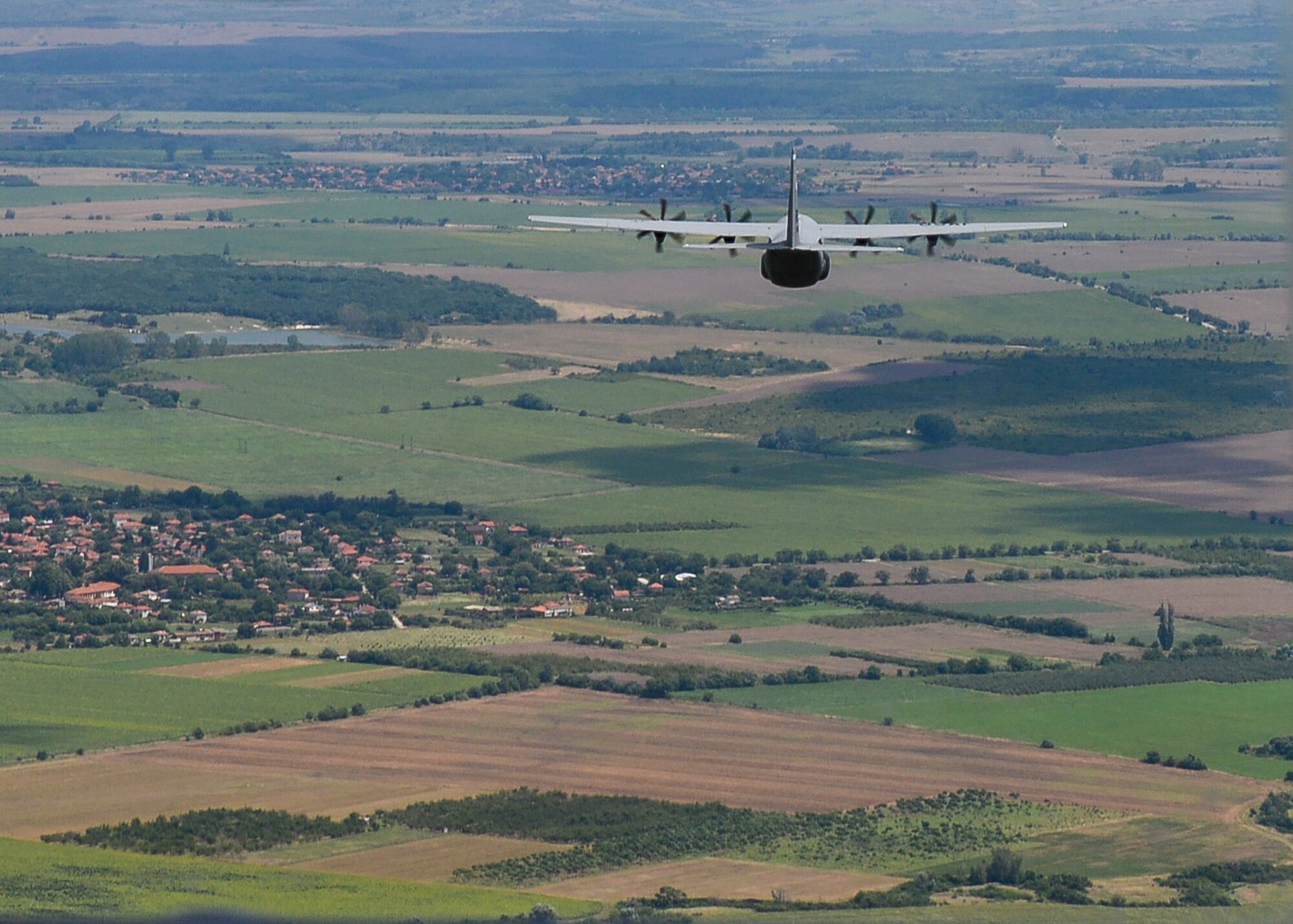 A U.S. Air Force C-130J Super Hercules aircraft flies over Plovdiv, Bulgaria, July 14, 2018. Pilots from the 37th Airlift Squadron performed low-level flying maneuvers, personnel and equipment airdrops, and night flying tactics. (U.S. Air Force photo by Staff Sgt. Jimmie D. Pike)