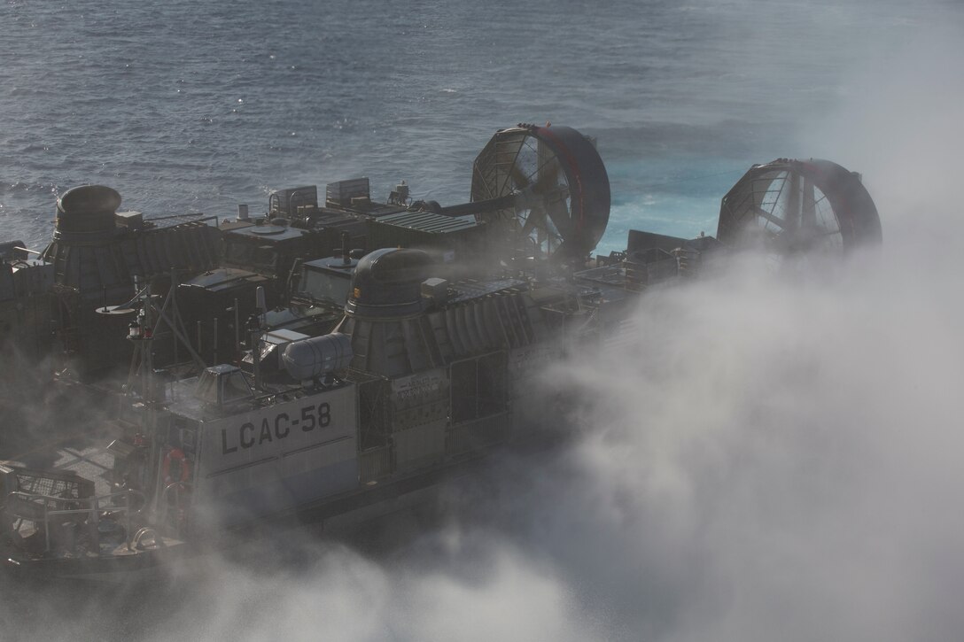 U.S. Navy Landing Craft, Air Cushion (LCAC) 58 prepares to enter the well deck of the amphibious assault ship USS Bonhomme Richard (LHD 6) during ship-to-shore operations with U.S. Marines and allied partners as part of Rim of the Pacific (RIMPAC) exercise at sea off the coast of Hawaii July 12, 2018.