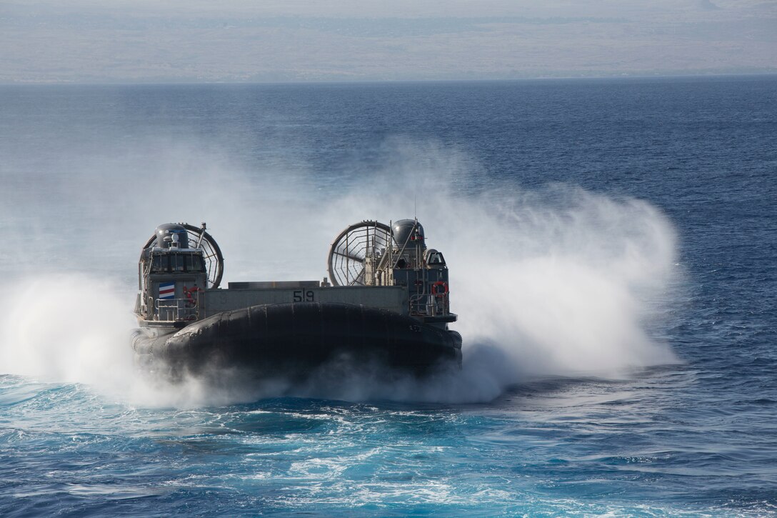 U.S. Navy Landing Craft, Air Cushion (LCAC) 58 prepares to enter the well deck of the amphibious assault ship USS Bonhomme Richard (LHD 6) during ship-to-shore operations with U.S. Marines and allied partners as part of Rim of the Pacific (RIMPAC) exercise at sea off the coast of Hawaii July 12, 2018.