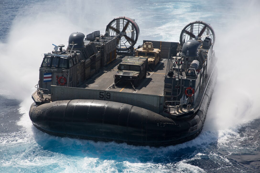 U.S. Navy Landing Craft, Air Cushion (LCAC) 58 departs the well deck of the amphibious assault ship USS Bonhomme Richard (LHD 6) during ship-to-shore operations with U.S. Marines and allied partners as part of Rim of the Pacific (RIMPAC) exercise at sea off the coast of Hawaii July 12, 2018.