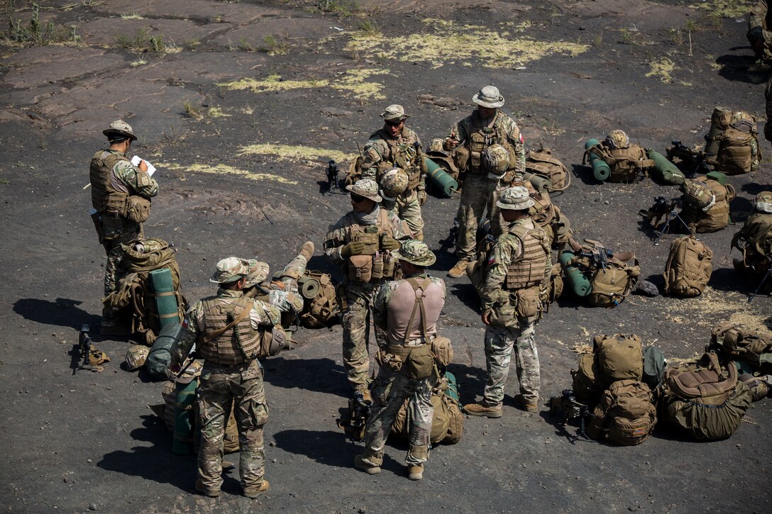 Chilean Marines drop their packs and recuperate after completing a hike during Rim of the Pacific (RIMPAC) exercise at Pohakuloa Training Area, Hawaii, July 15, 2018.