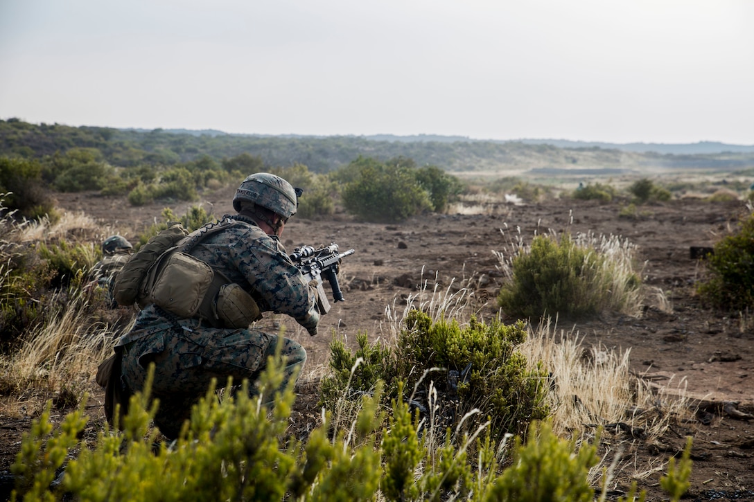U.S. Marine Corps Cpl. Walter Sanderson, a squad leader with Golf Company, 2nd Battalion, 4th Marine Regiment, takes cover during a live-fire training event as part of Rim of the Pacific (RIMPAC) exercise at Pohakuloa Training Area, Hawaii, July 15, 2018.