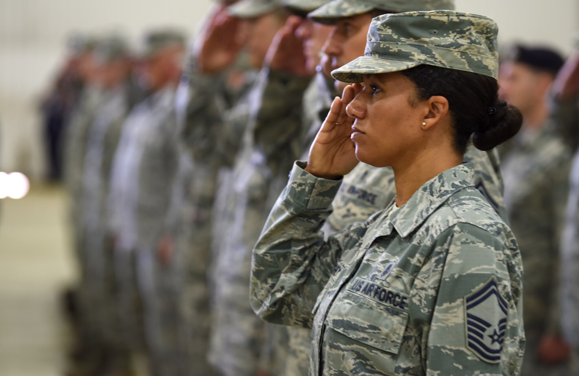 48th Fighter Wing Airmen salute in formation during the wing change of command ceremony at Royal Air Force Lakenheath, England, July 16, 2018. The ceremony is a military tradition that formally expresses the transfer of responsibility of a unit from one commanding officer to another. (U.S. Air Force photo by Staff Sgt. Alex Fox Echols III)