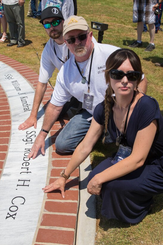Family pose next to the name of late Marine Staff Sgt. Robert H. Cox, on a marble monument honoring the fallen Marines and sailor, lost in a 2017 plane crash near Itta Bena, Miss., Jul 14, 2018. More than 200 relatives and friends of the 16 people who died aboard the flight with the call sign Yanky 72, joined by countless county residents and military supporters at the ceremonies on campus of Mississippi Valley State University and across the street. (U.S. Marine Corps photo by Lance Cpl. Samantha Schwoch/released)